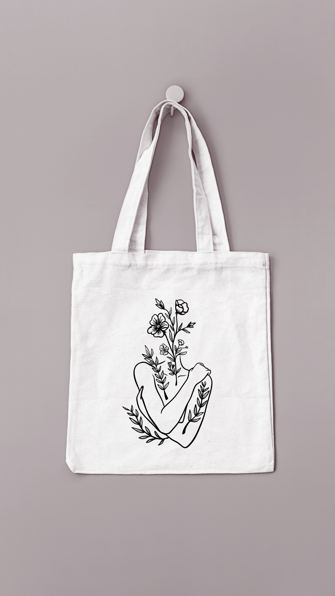 Sac réutilisable de couleur crème avec un buste de femme avec une tête fleurie floqué en noir